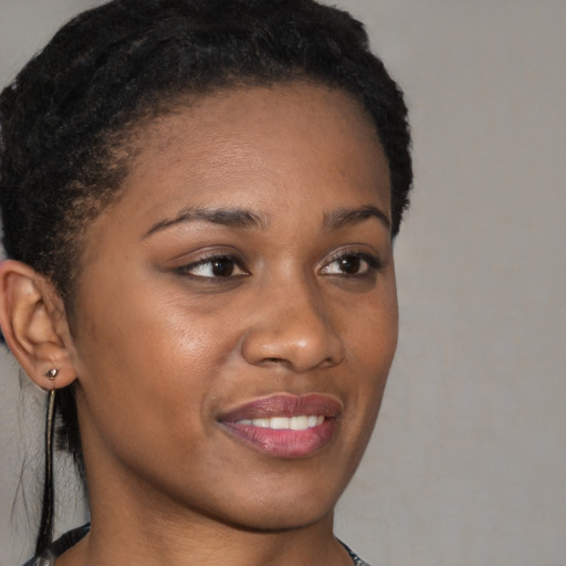 Joyful black young-adult female with short  brown hair and brown eyes