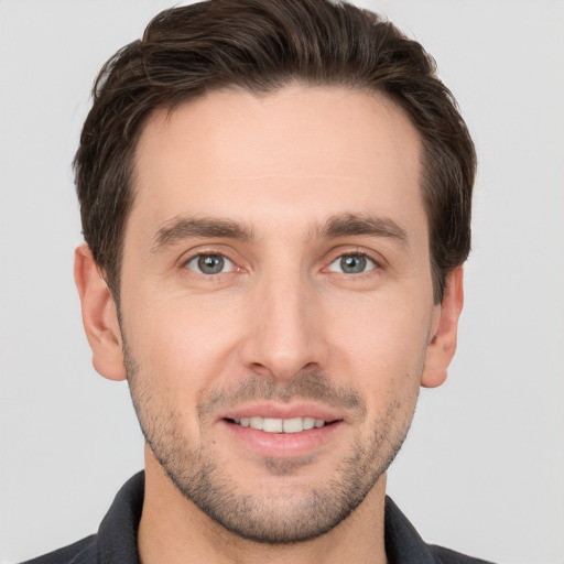 Joyful white young-adult male with short  brown hair and brown eyes