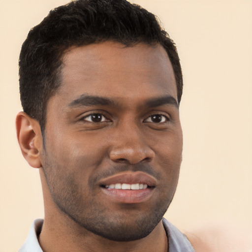 Joyful black young-adult male with short  brown hair and brown eyes