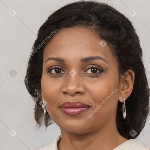 Joyful black adult female with medium  brown hair and brown eyes