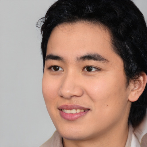 Joyful asian young-adult male with medium  brown hair and brown eyes