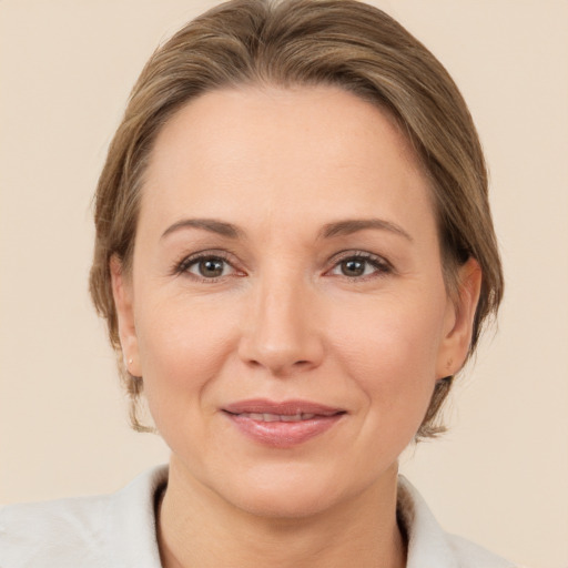 Joyful white adult female with medium  brown hair and brown eyes