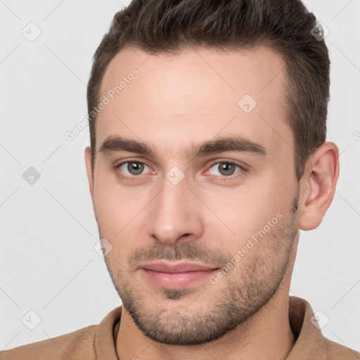 Joyful white young-adult male with short  brown hair and brown eyes