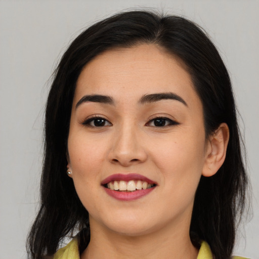 Joyful asian young-adult female with long  brown hair and brown eyes