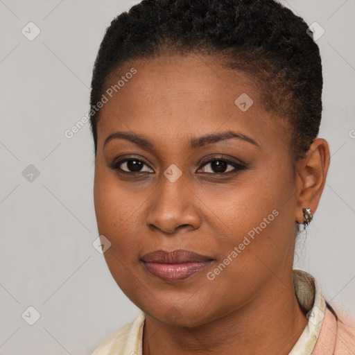 Joyful black young-adult female with short  brown hair and brown eyes