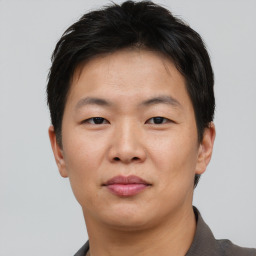 Neutral asian young-adult male with short  brown hair and brown eyes