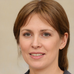 Joyful white young-adult female with medium  brown hair and blue eyes