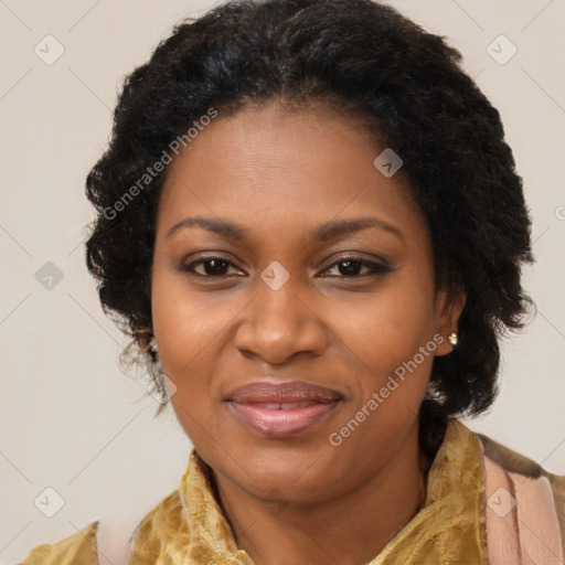 Joyful black adult female with long  brown hair and brown eyes