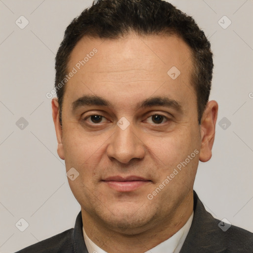 Joyful white adult male with short  black hair and brown eyes