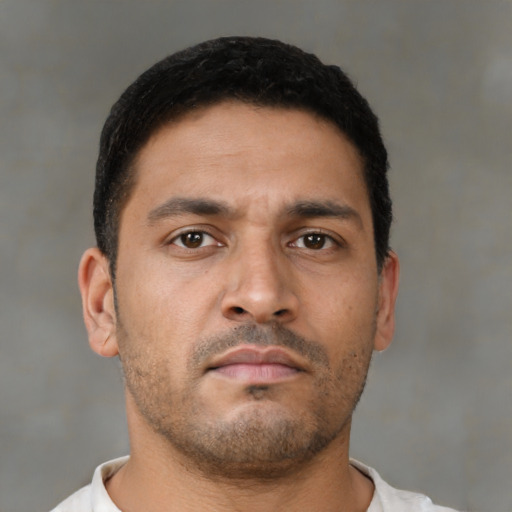 Neutral latino young-adult male with short  brown hair and brown eyes