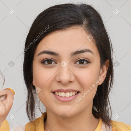 Joyful latino young-adult female with medium  brown hair and brown eyes