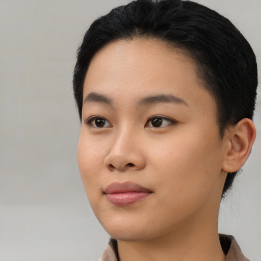 Joyful asian young-adult female with medium  black hair and brown eyes
