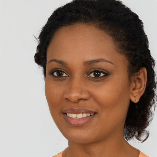 Joyful black young-adult female with medium  brown hair and brown eyes
