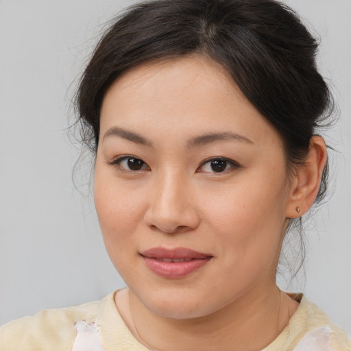 Joyful asian young-adult female with medium  brown hair and brown eyes
