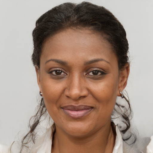 Joyful black young-adult female with short  brown hair and brown eyes
