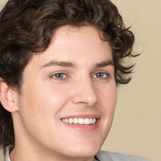 Joyful white young-adult male with medium  brown hair and brown eyes