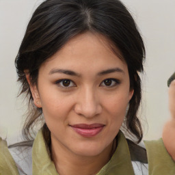 Joyful asian young-adult female with medium  brown hair and brown eyes