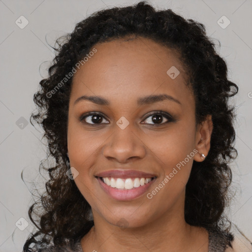 Joyful black young-adult female with long  brown hair and brown eyes