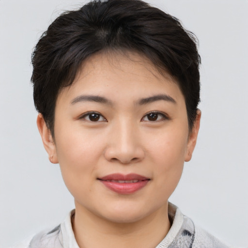 Joyful asian young-adult female with short  brown hair and brown eyes