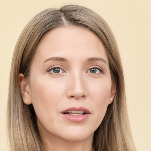 Joyful white young-adult female with long  brown hair and grey eyes