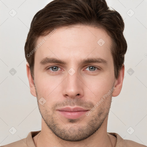 Joyful white young-adult male with short  brown hair and grey eyes