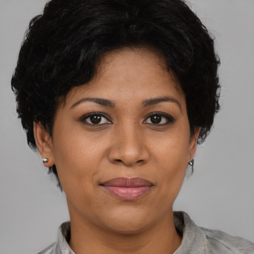 Joyful latino adult female with short  brown hair and brown eyes