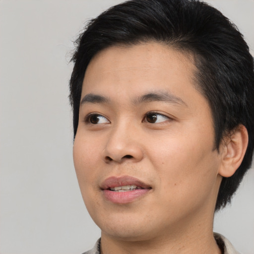 Joyful asian young-adult male with medium  black hair and brown eyes