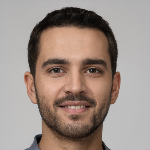 Joyful white young-adult male with short  brown hair and brown eyes