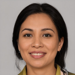 Joyful latino young-adult female with medium  brown hair and brown eyes