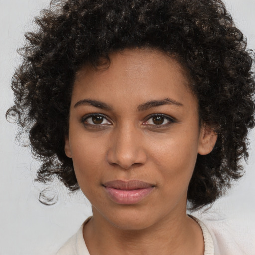 Joyful black young-adult female with medium  brown hair and brown eyes