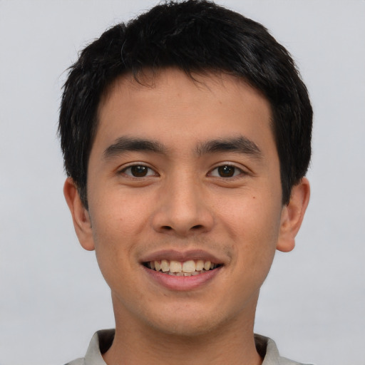 Joyful asian young-adult male with short  brown hair and brown eyes