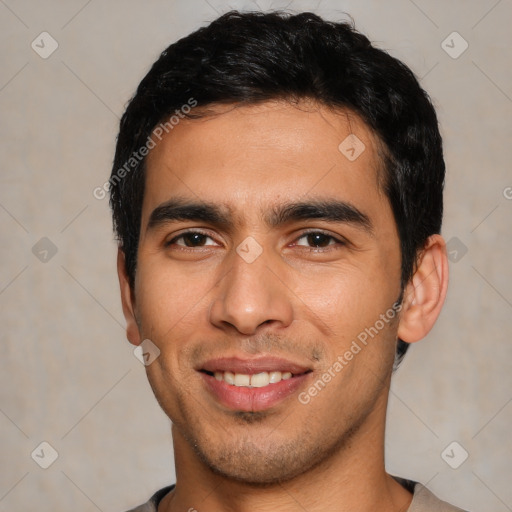 Joyful white young-adult male with short  black hair and brown eyes