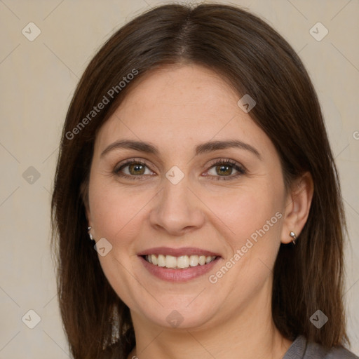 Joyful white adult female with long  brown hair and brown eyes