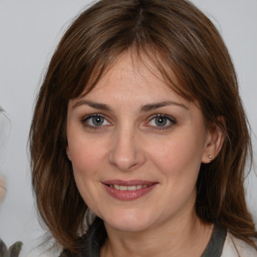 Joyful white adult female with medium  brown hair and brown eyes