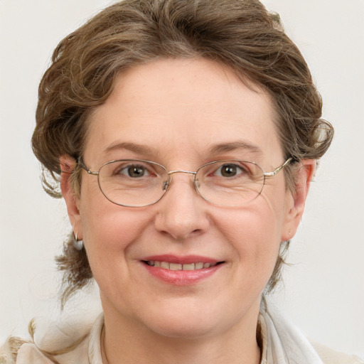 Joyful white adult female with medium  brown hair and blue eyes