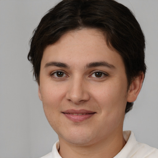 Joyful white young-adult female with short  brown hair and brown eyes