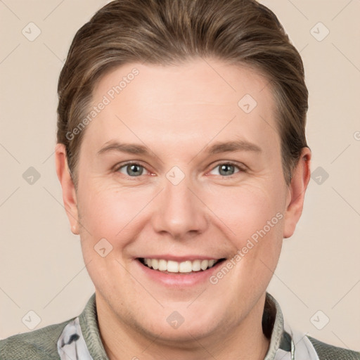 Joyful white young-adult male with short  brown hair and grey eyes