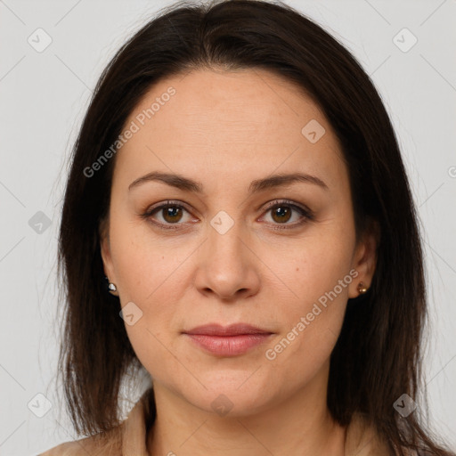 Joyful white adult female with long  brown hair and brown eyes