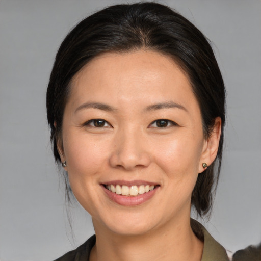 Joyful white young-adult female with medium  brown hair and brown eyes