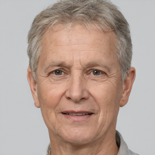 Joyful white middle-aged male with short  gray hair and brown eyes