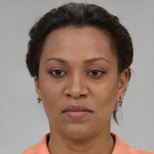 Joyful black adult female with short  brown hair and brown eyes
