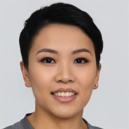 Joyful asian young-adult female with short  black hair and brown eyes