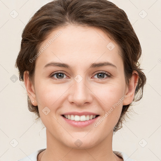 Joyful white young-adult female with medium  brown hair and grey eyes