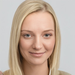 Joyful white young-adult female with long  blond hair and grey eyes