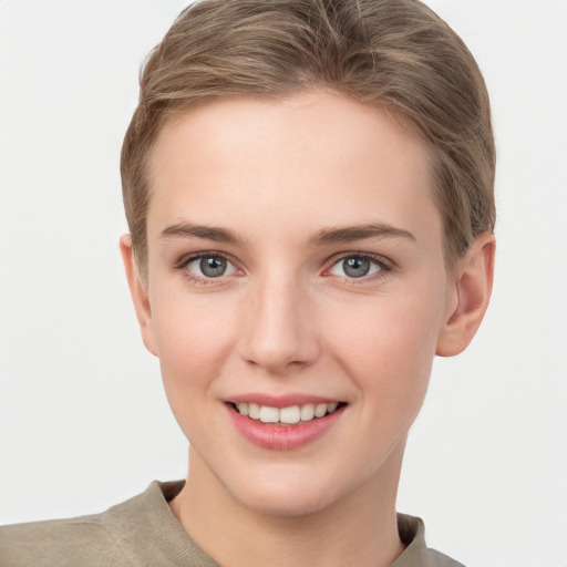 Joyful white young-adult female with short  brown hair and grey eyes