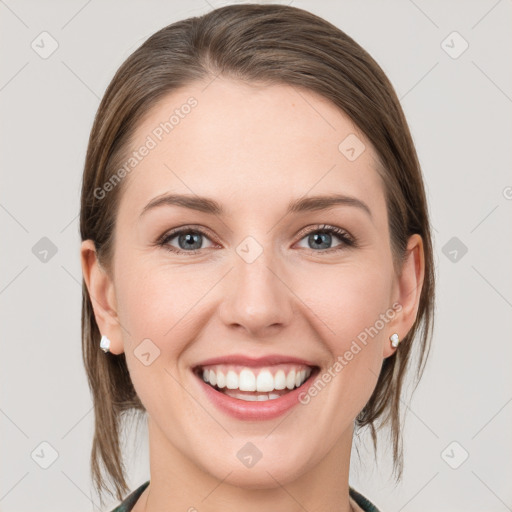 Joyful white young-adult female with medium  brown hair and grey eyes