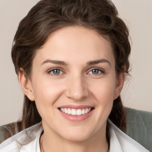 Joyful white young-adult female with medium  brown hair and grey eyes