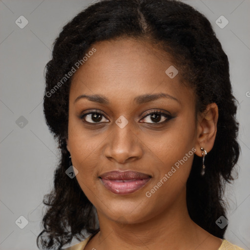 Joyful black young-adult female with medium  brown hair and brown eyes