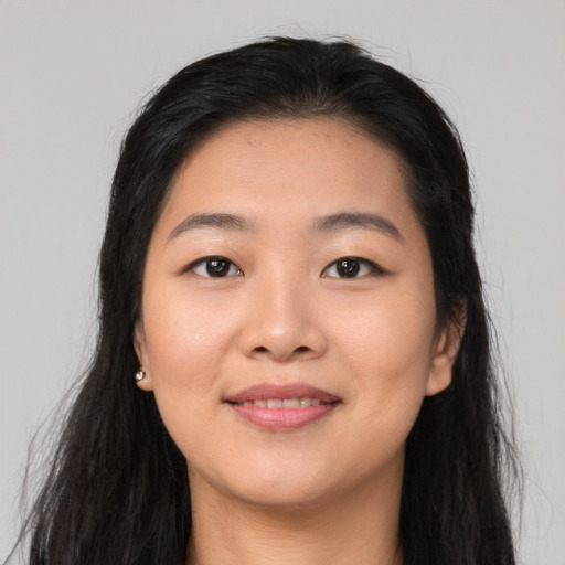 Joyful asian young-adult female with long  black hair and brown eyes