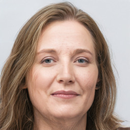 Joyful white adult female with long  brown hair and grey eyes